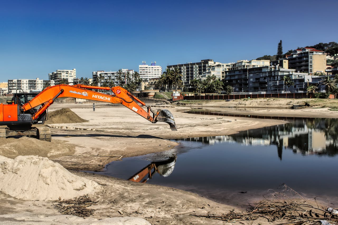 Home Excavator working on beach reclamation in Margate, showcasing urban development.